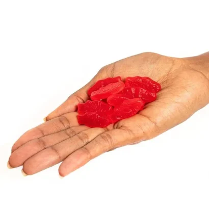 Hand Holding Swedish Fish Mini Red Candy – Portion Size Display – Soft and Chewy Texture – Perfect for On-the-Go Snacking